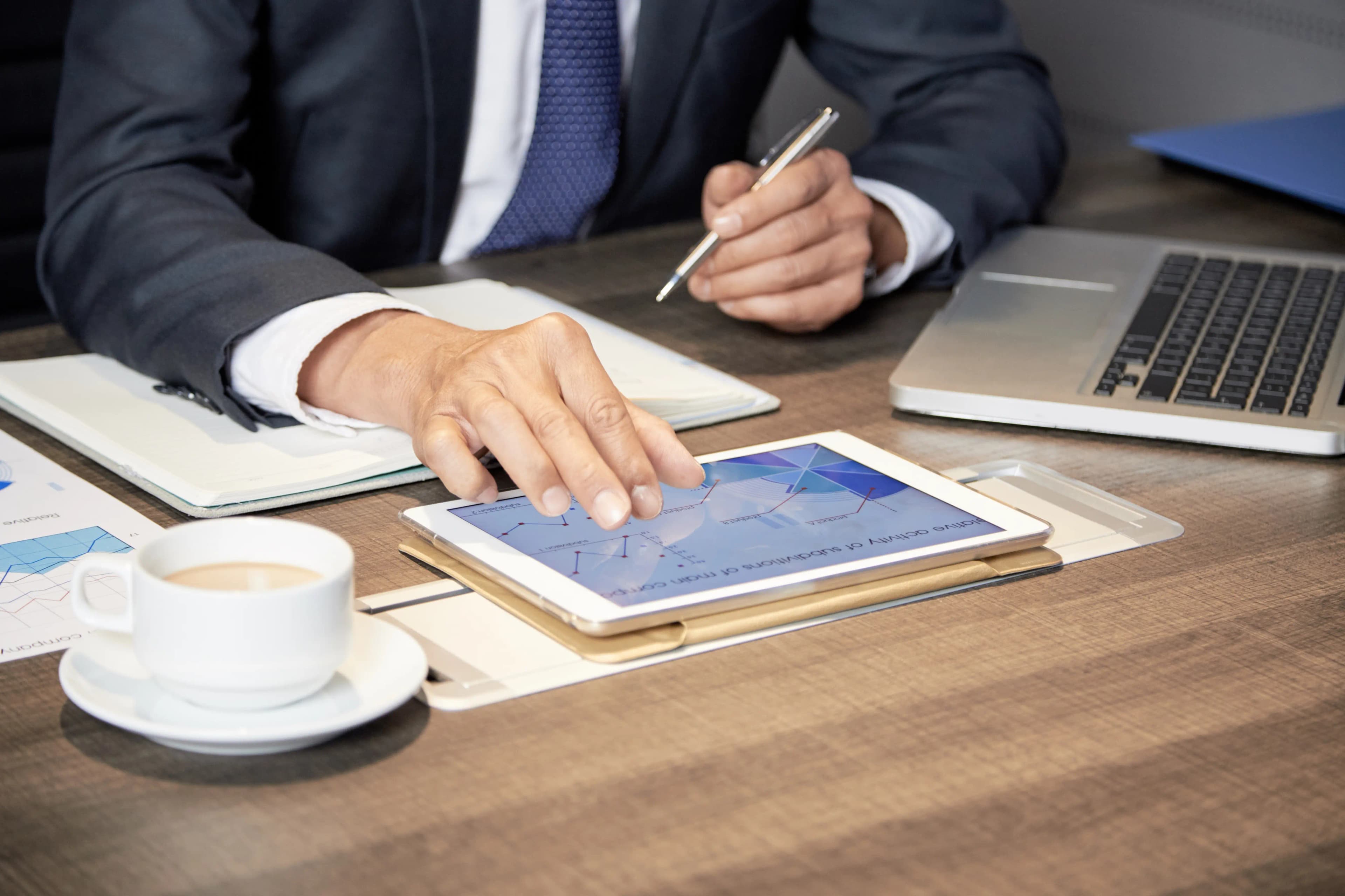 Crop businessman using tablet table